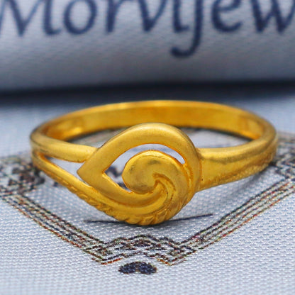 Gold ring with intricate design on a textured fabric background with 'Morvijewels' branding.